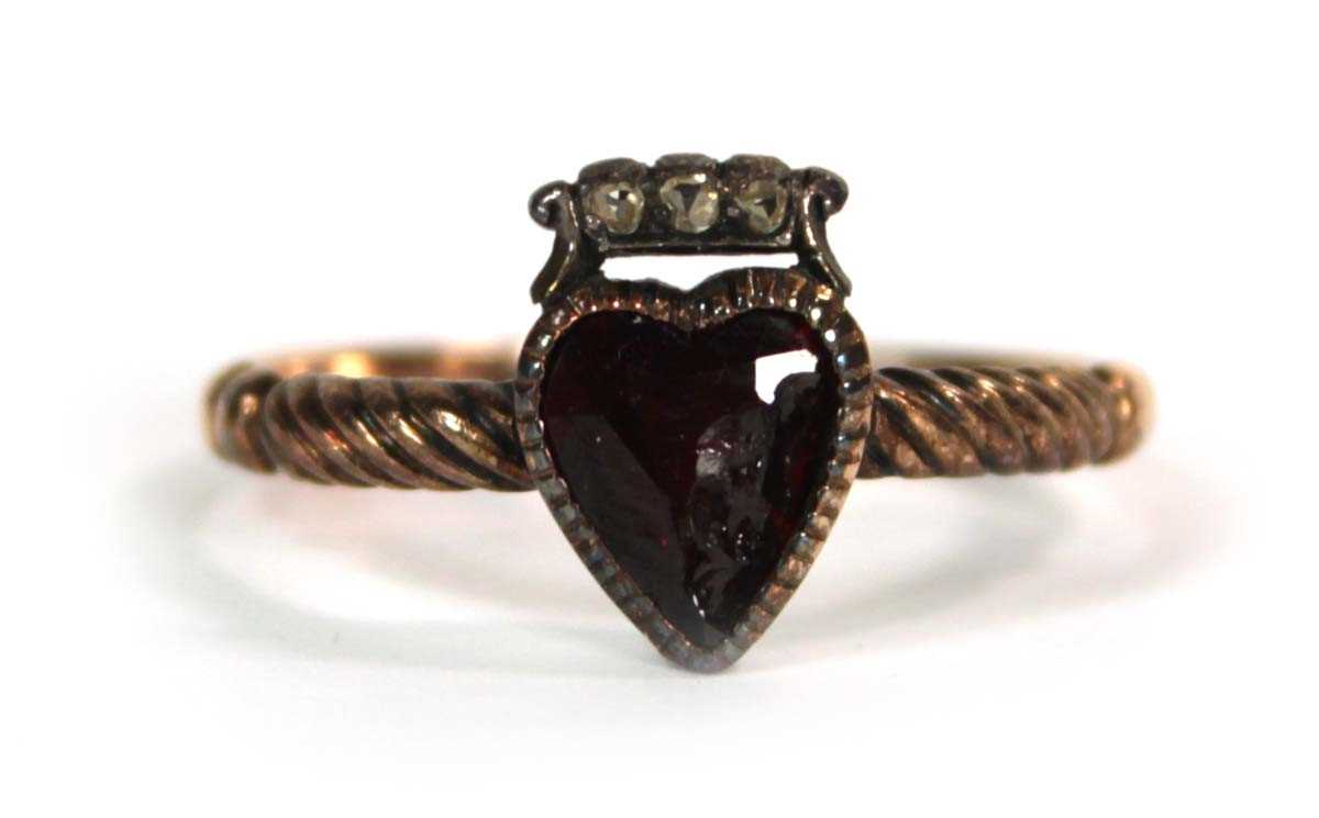 Lot 523 - A 19th century yellow metal ring set heart...