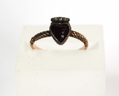 Lot 523 - A 19th century yellow metal ring set heart...