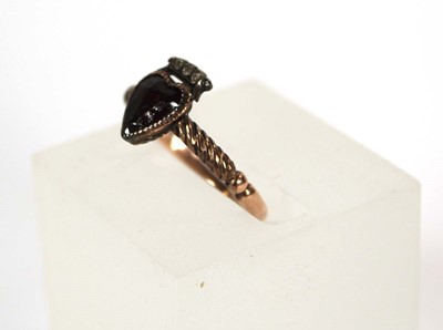 Lot 523 - A 19th century yellow metal ring set heart...