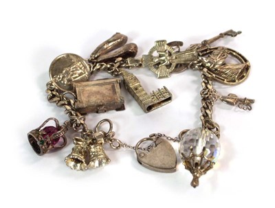 Lot 525 - A silver flat curblink bracelet with heart...