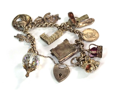 Lot 525 - A silver flat curblink bracelet with heart...