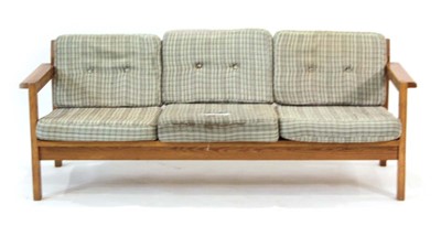 Lot 19 - A 1970's pine three-seater sofa on square...