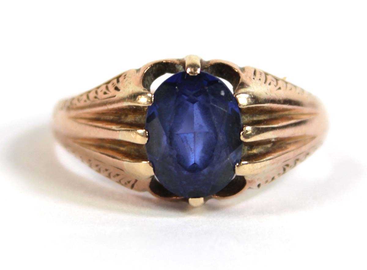 Lot 530 - A 9ct rose gold ring set oval synthetic...
