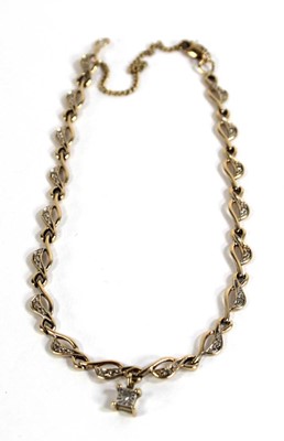 Lot 536 - A 9ct yellow gold swirl link bracelet set...