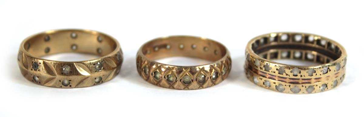 Lot 545 - Three 9ct yellow gold eternity rings set paste,...