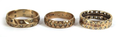 Lot 545 - Three 9ct yellow gold eternity rings set paste,...