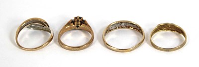 Lot 547 - Four 9ct yellow gold rings, each set diamonds...