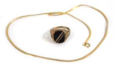 Lot 552 - A 9ct yellow gold signet ring set black...