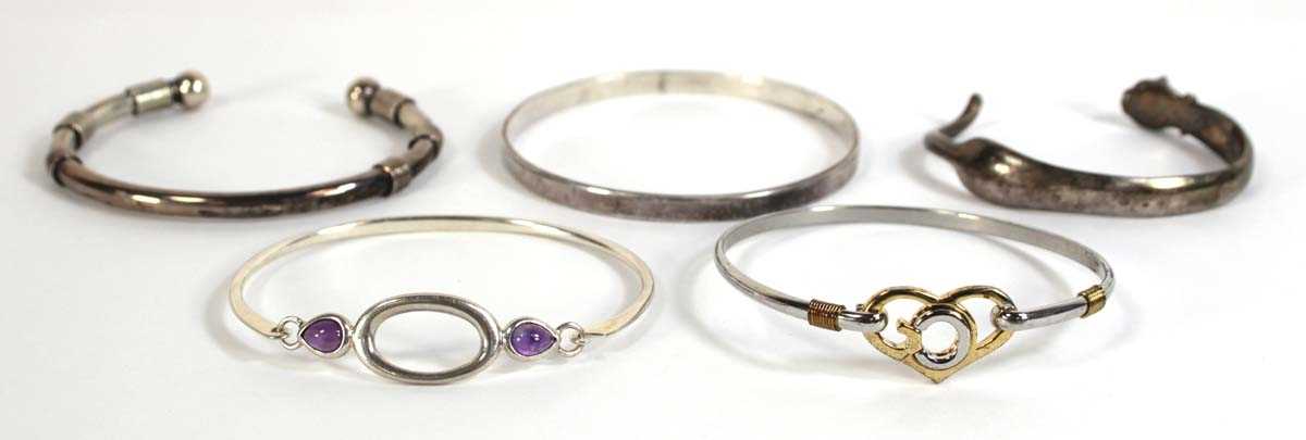 Lot 553 - Five silver and metalware cuff and hinged...