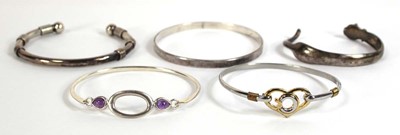Lot 553 - Five silver and metalware cuff and hinged...