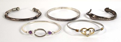 Lot 553 - Five silver and metalware cuff and hinged...