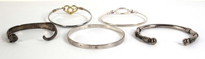 Lot 553 - Five silver and metalware cuff and hinged...