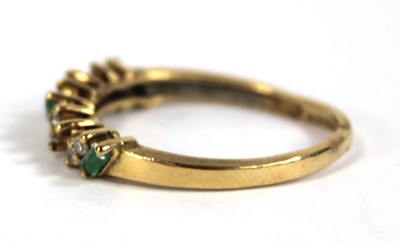 Lot 557 - An 18ct yellow gold half eternity ring set...