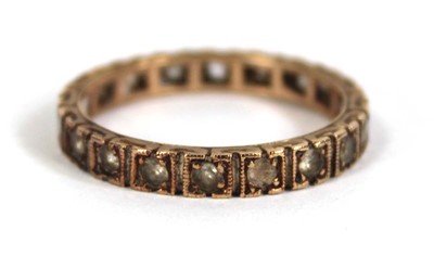 Lot 560 - A 9ct yellow gold eternity ring set paste,...