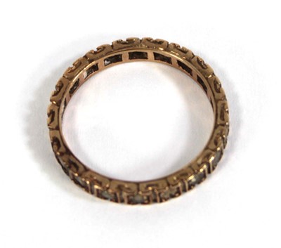 Lot 560 - A 9ct yellow gold eternity ring set paste,...