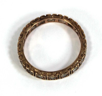 Lot 560 - A 9ct yellow gold eternity ring set paste,...