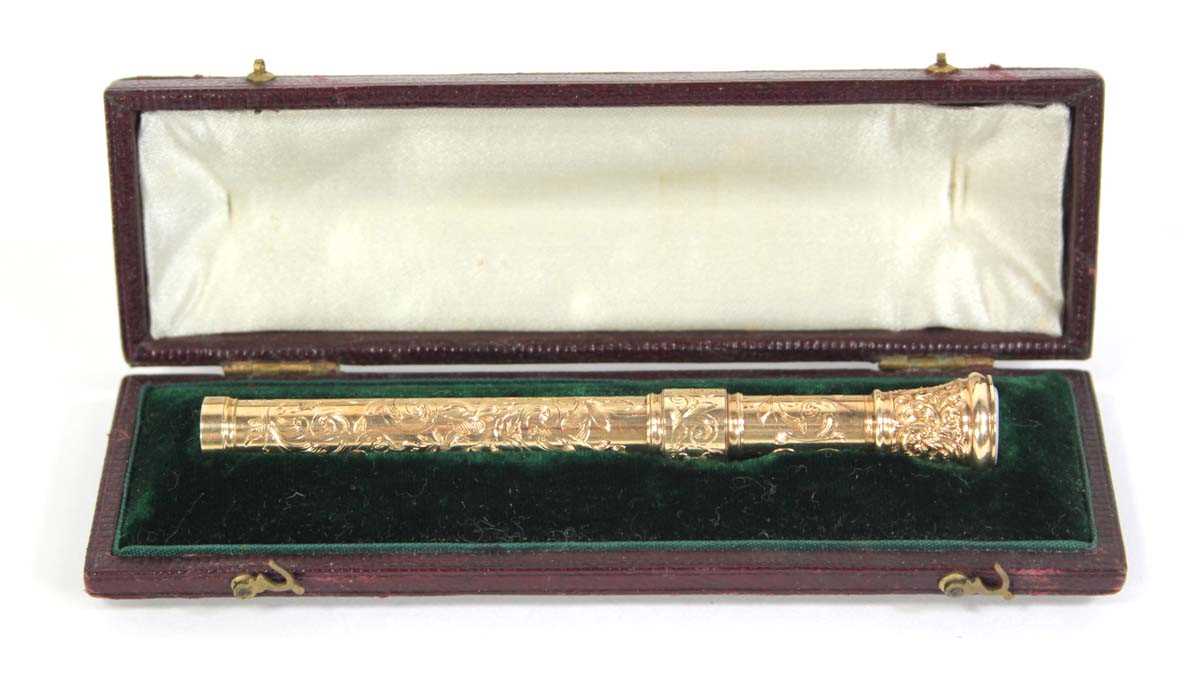 Lot 567 - A yellow metal scroll engraved propelling...