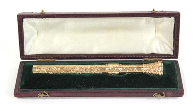 Lot 567 - A yellow metal scroll engraved propelling...
