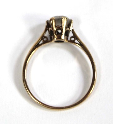 Lot 571 - A 9ct yellow gold ring set paste in a six claw...