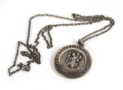 Lot 576 - A silver chainlink necklace suspending a...