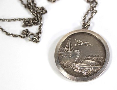 Lot 576 - A silver chainlink necklace suspending a...