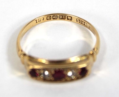 Lot 577 - An 18ct yellow gold ring set three small...