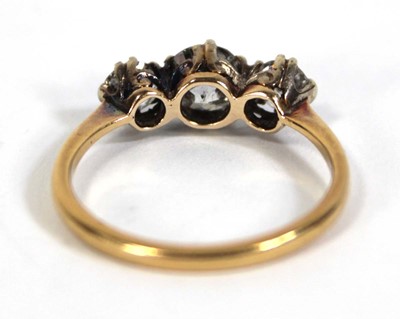 Lot 583 - An 18ct yellow gold ring set three graduated...