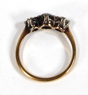Lot 583 - An 18ct yellow gold ring set three graduated...