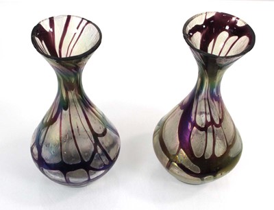 Lot 45 - In the manner of Loetz, a pair of iridescent...