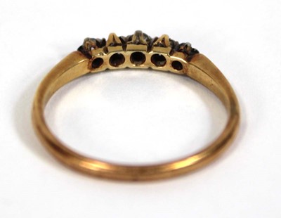 Lot 587 - An 18ct yellow gold ring set five small...