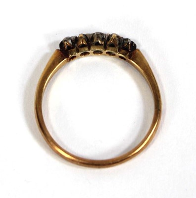 Lot 587 - An 18ct yellow gold ring set five small...