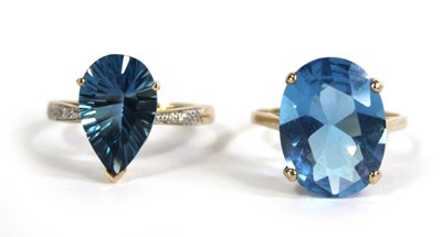 Lot 701 - Two 9ct yellow gold dress rings set pale blue...