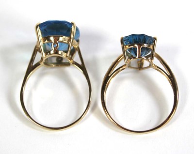 Lot 701 - Two 9ct yellow gold dress rings set pale blue...
