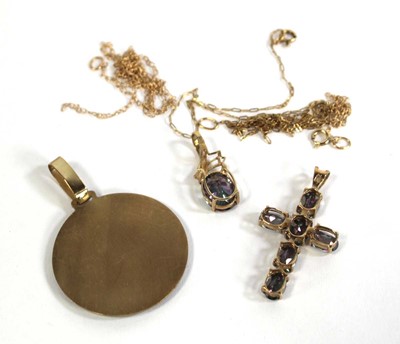 Lot 702 - Three 9ct yellow gold pendants including a...