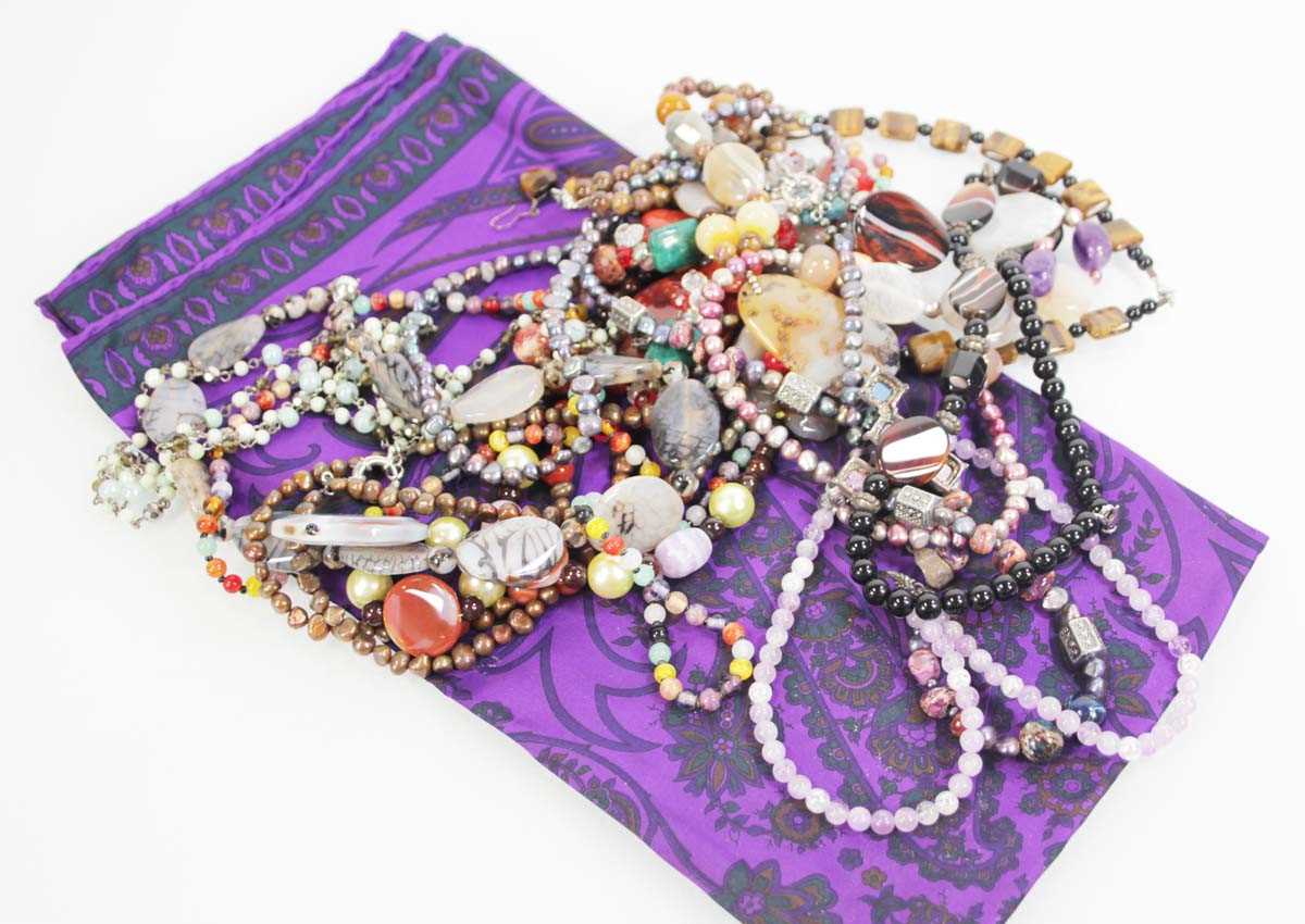 Lot 714 - A group of beaded jewellery including a tigers...
