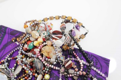 Lot 714 - A group of beaded jewellery including a tigers...