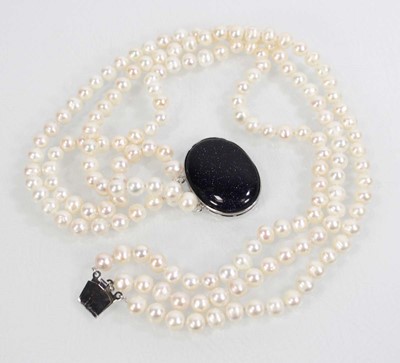 Lot 719 - A triple strand cultured pearl necklace with...