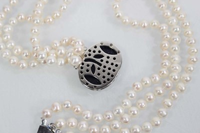 Lot 719 - A triple strand cultured pearl necklace with...