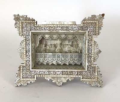 Lot 118 - An olive wood and mother-of-pearl relief...