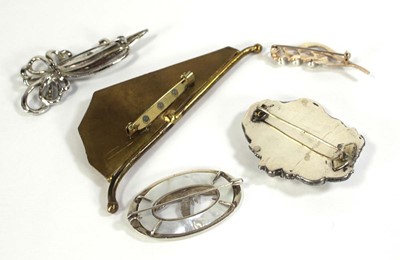 Lot 589 - A silver brooch of oval form decorated with a...