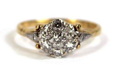 Lot 593 - An 18ct yellow gold cluster ring set seven...