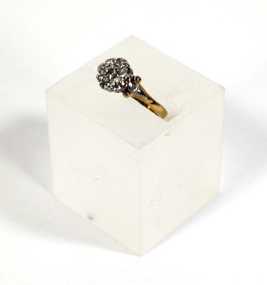 Lot 593 - An 18ct yellow gold cluster ring set seven...