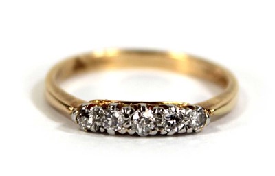 Lot 595 - An 18ct yellow gold ring set five small...