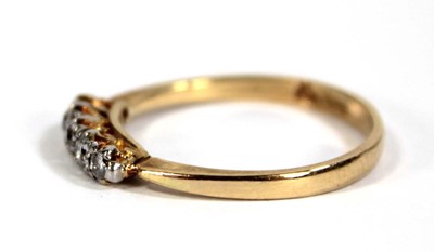 Lot 595 - An 18ct yellow gold ring set five small...