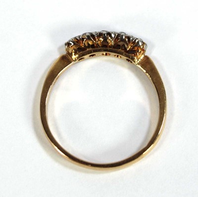 Lot 595 - An 18ct yellow gold ring set five small...