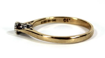 Lot 599 - A 9ct yellow gold ring set small diamond in an...