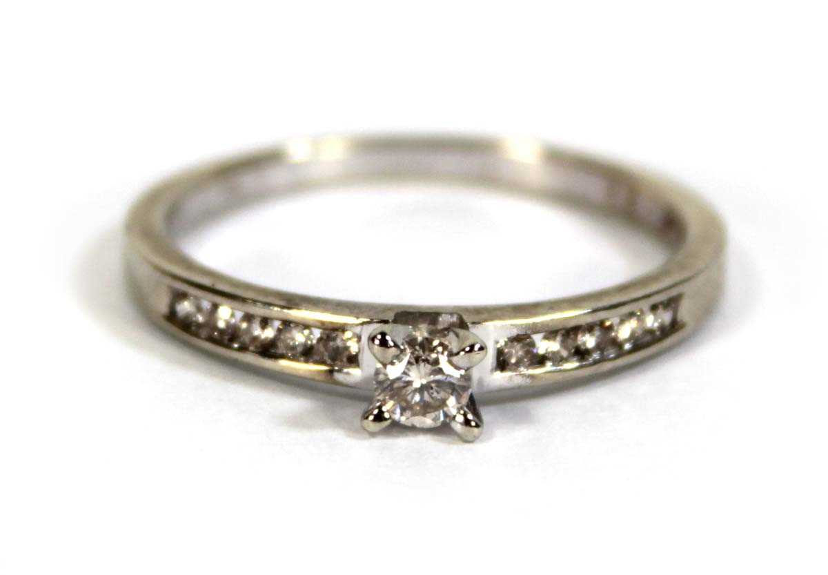 Lot 600 - A 9ct white gold ring set small diamond in a...