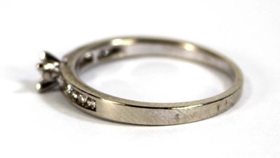 Lot 600 - A 9ct white gold ring set small diamond in a...