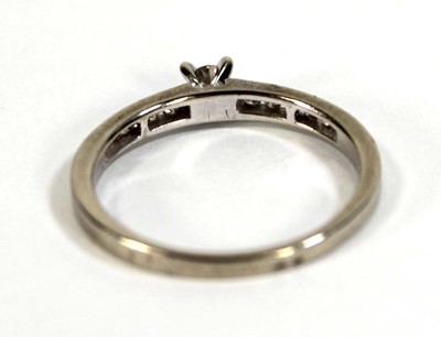 Lot 600 - A 9ct white gold ring set small diamond in a...