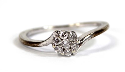 Lot 601 - A 9ct white gold cluster ring set seven small...
